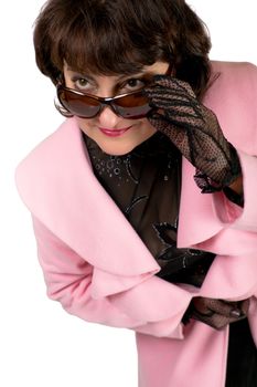 A woman in a pink coat and glasses