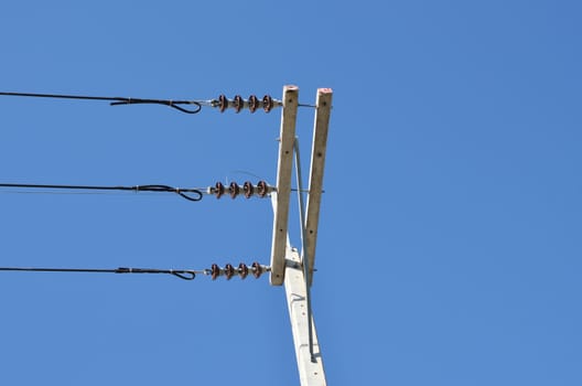 electricity post with blue sky