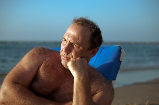 Relaxed man  on the beach .