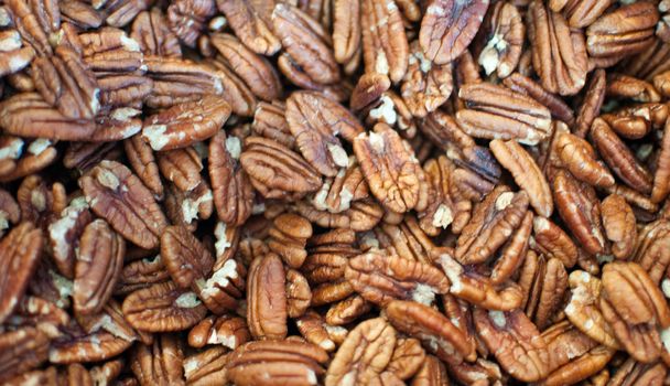 Bunch of pecan nuts background .