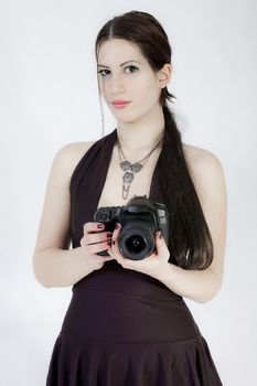 portrait of young woman with photo camera