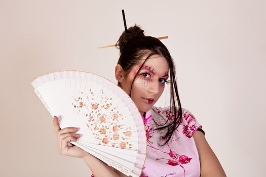 traditional make up. geisha with a fan