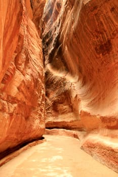 Rosy red walls of the Siq canyon, leading to the Treasury in Petra, Jordan.