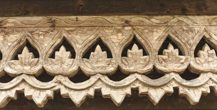 Carved wooden lattice work with Thai style pattern art in Thailand.