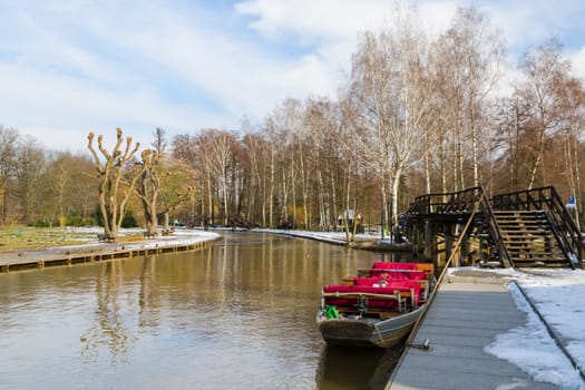Boat near the pier on springtime canal in european national park