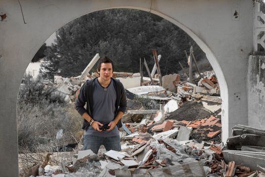 Guy playing with his console surrounded by rubble, a concept