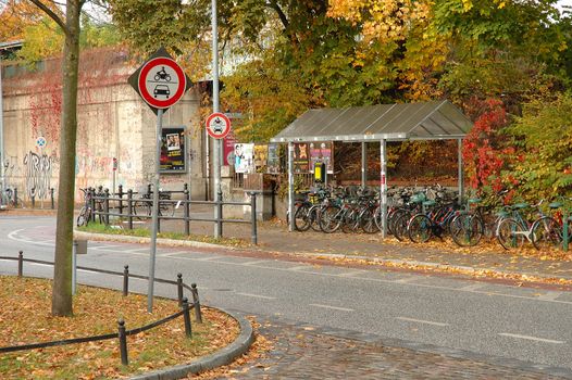 POTSDAM, GERMANY - OCTOBER 20: Signs, bicycles and autumn leaves nearby railway station in Potsdam Germany 20.10.2013