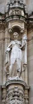 A sculpture at the facade of an old building in Antwerp.