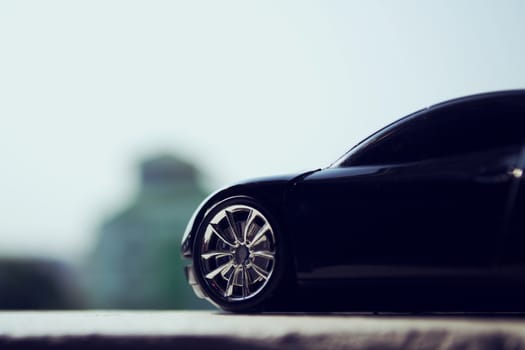 Black car in retro concept with city sky