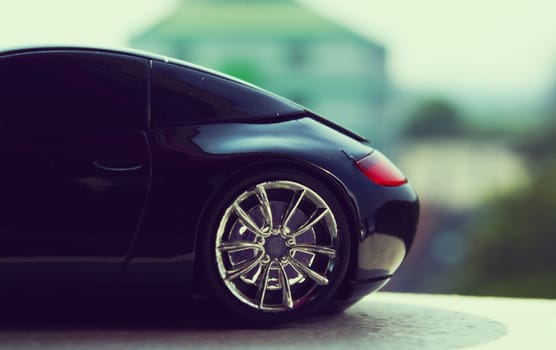 Black car in retro concept with city sky