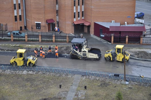 Special equipment on repair of roads. Bulldozer, asphalt spreader.