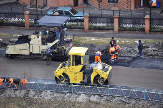 Special equipment on repair of roads. Bulldozer, asphalt spreader.