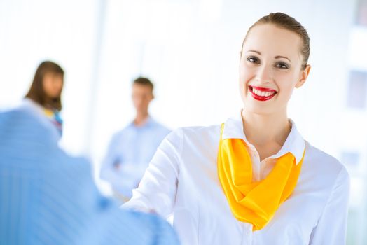 Business woman shaking hands and smiling colleague