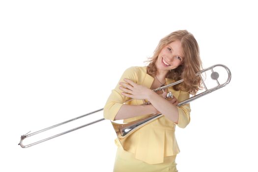 young woman in yellow holding trombone and white background