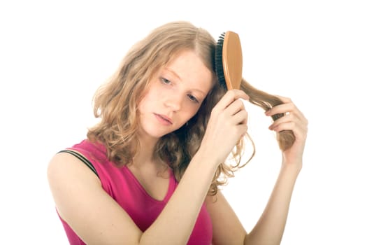 reddish girl combing her hair against white background