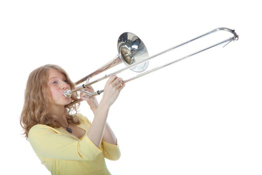 young woman in yellow with trombone against white background