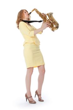young woman in yellow mini dress playing the alto saxophone against white background