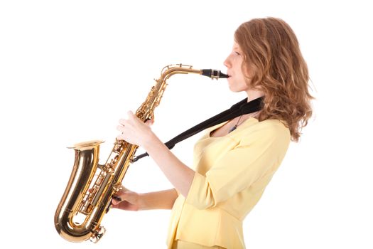 young woman in yellow playing the alto saxophone against white background