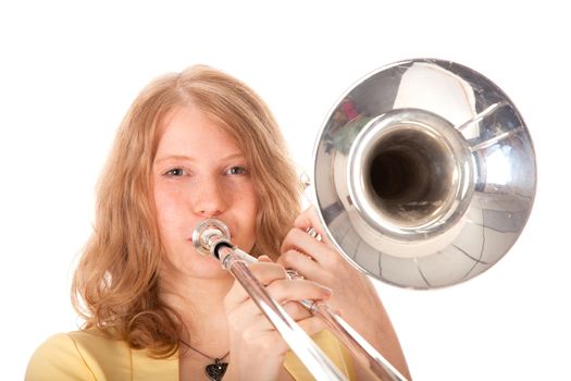 closeup of young woman in yellow holding trombone and white background