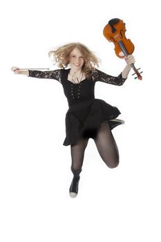 girl with violin jumping into the air against white background