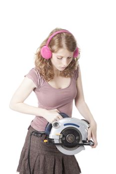 young pretty woman with circular saw against white background