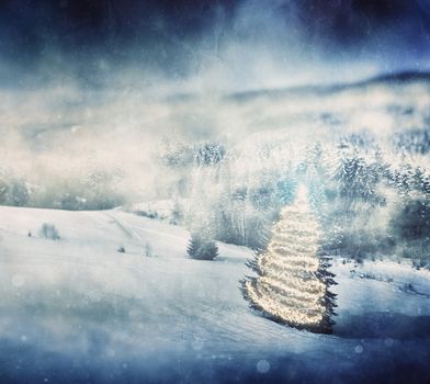 Christmas tree glowing in winter scenery, mountains during snow storm. Vintage texture.