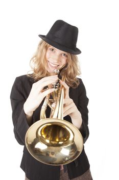 smiling girl with trumpet and black hat against white background
