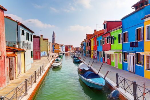 Colorful houses and canal on Burano island, near Venice, Italy. Sunny day.