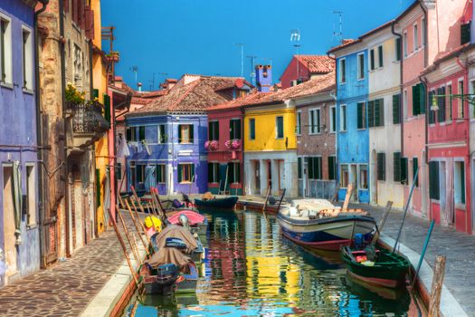 Colorful houses and canal on Burano island, near Venice, Italy. Sunny day.