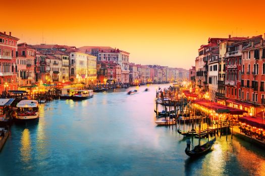 Venice, Italy. Gondola floats on Grand Canal, Italian Canal Grande at sunset. View from Rialto Bridge