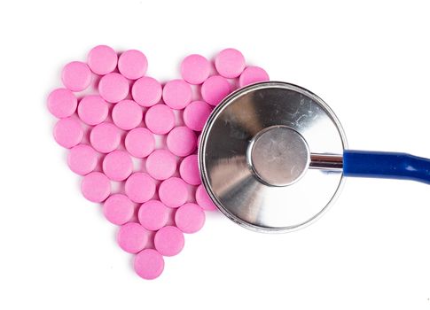 Closeup view of blue stethoscope on a heart shaped pills