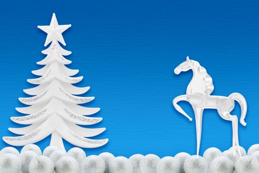 Christmas tree and horse on a background of blue paper