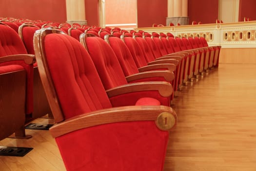 Background of many red theatrical red chairs