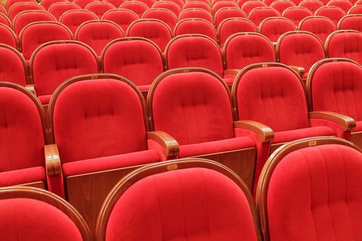 Background of many red theatrical red chairs
