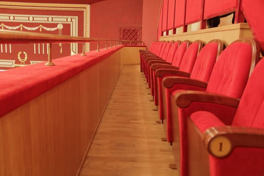 Background of many red theatrical red chairs