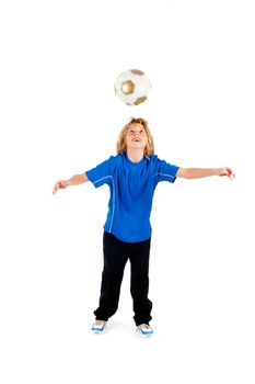 Portrait of a young soccer player heading ball isolated over white background