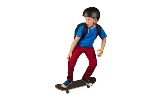 a 9 year old boy skateboarding to school with his backpack and helmet on.