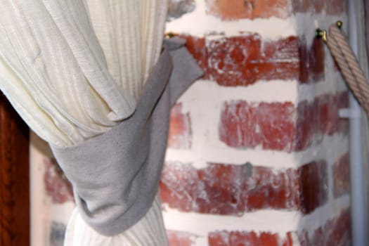 flax curtain on brick wall