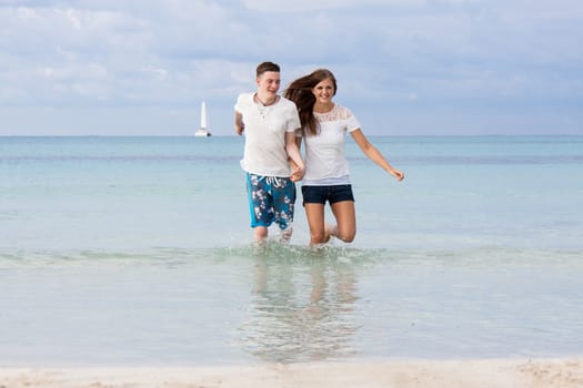 young happy couple in summer holiday vacation summertime beach