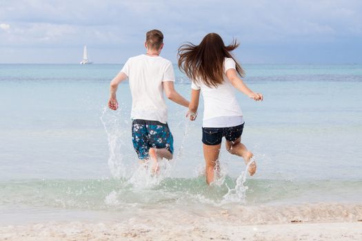 young happy couple in summer holiday vacation summertime beach