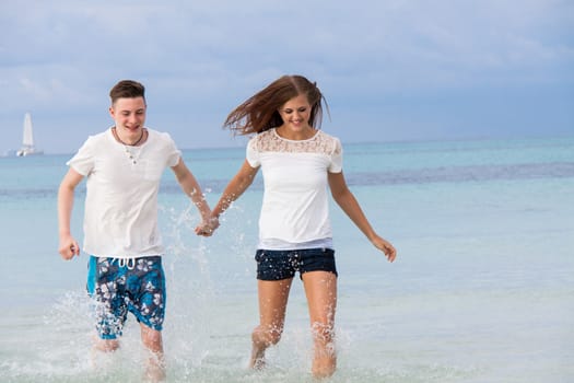 young happy couple in summer holiday vacation summertime beach