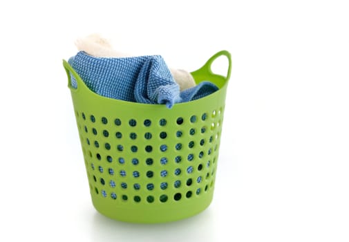 fabric in green plastic basket isolated on white