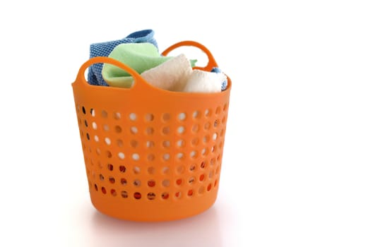 fabric in orange plastic basket isolated on white