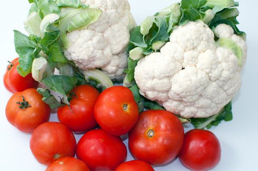 Freshly cut  cauliflower cabbage  and tomatoes isolated on white .