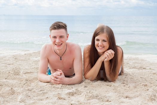 young happy couple in summer holiday vacation summertime beach