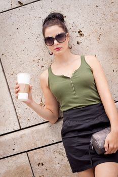 attractive young woman with smartphone and sunglasses outdoor in summer