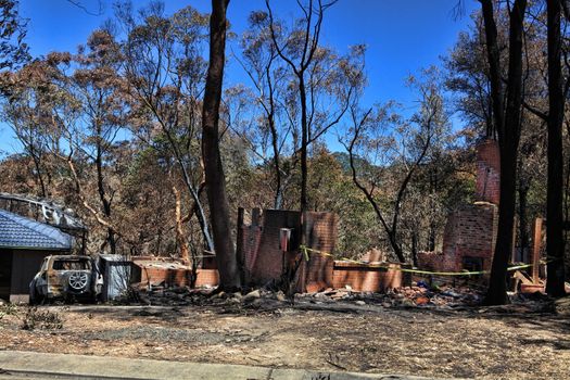 After the fire.   Bushfire destroys homes and vehicles in a random pattern while some are spared completely, others are razed to the ground.