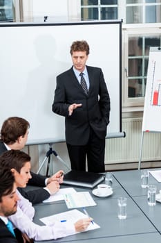 business team on table in office conference seminar presentation