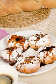 Portion of sufganiyah served with freshly made coffee