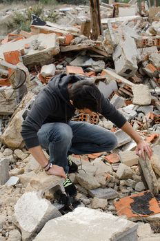 Guy rummaging in a whole lot of construction debris